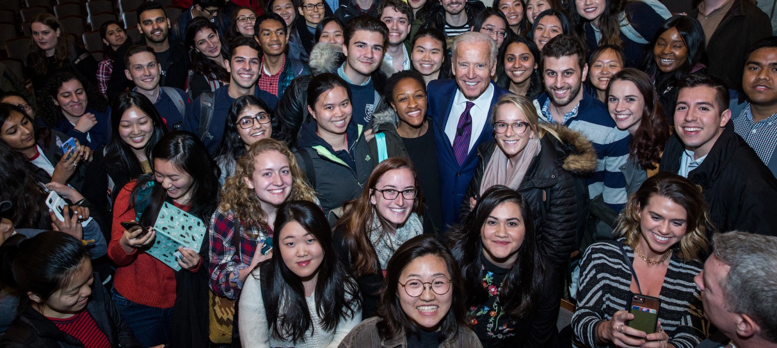 Joe Biden takes a photo with Penn students after a speaking event.