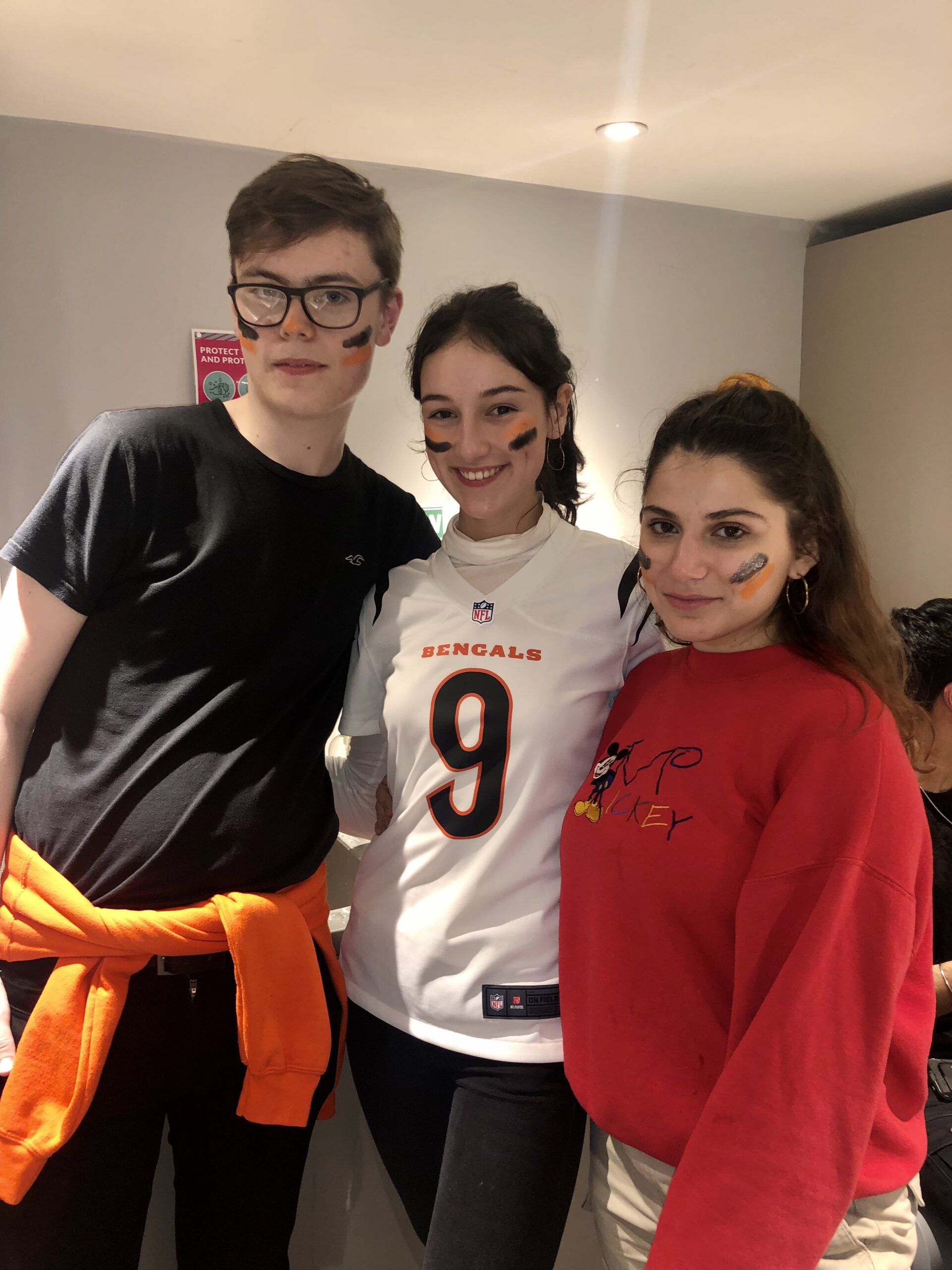 Bebe wearing her jersey and posing with friends