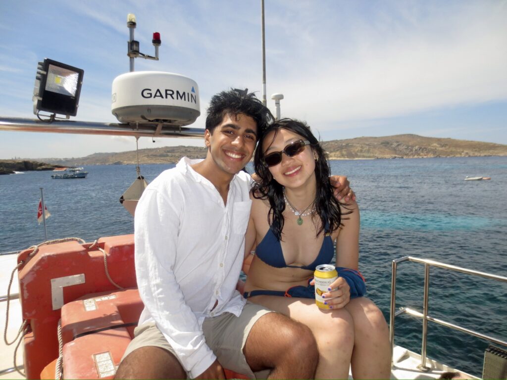 Arnav with a friend on a boat