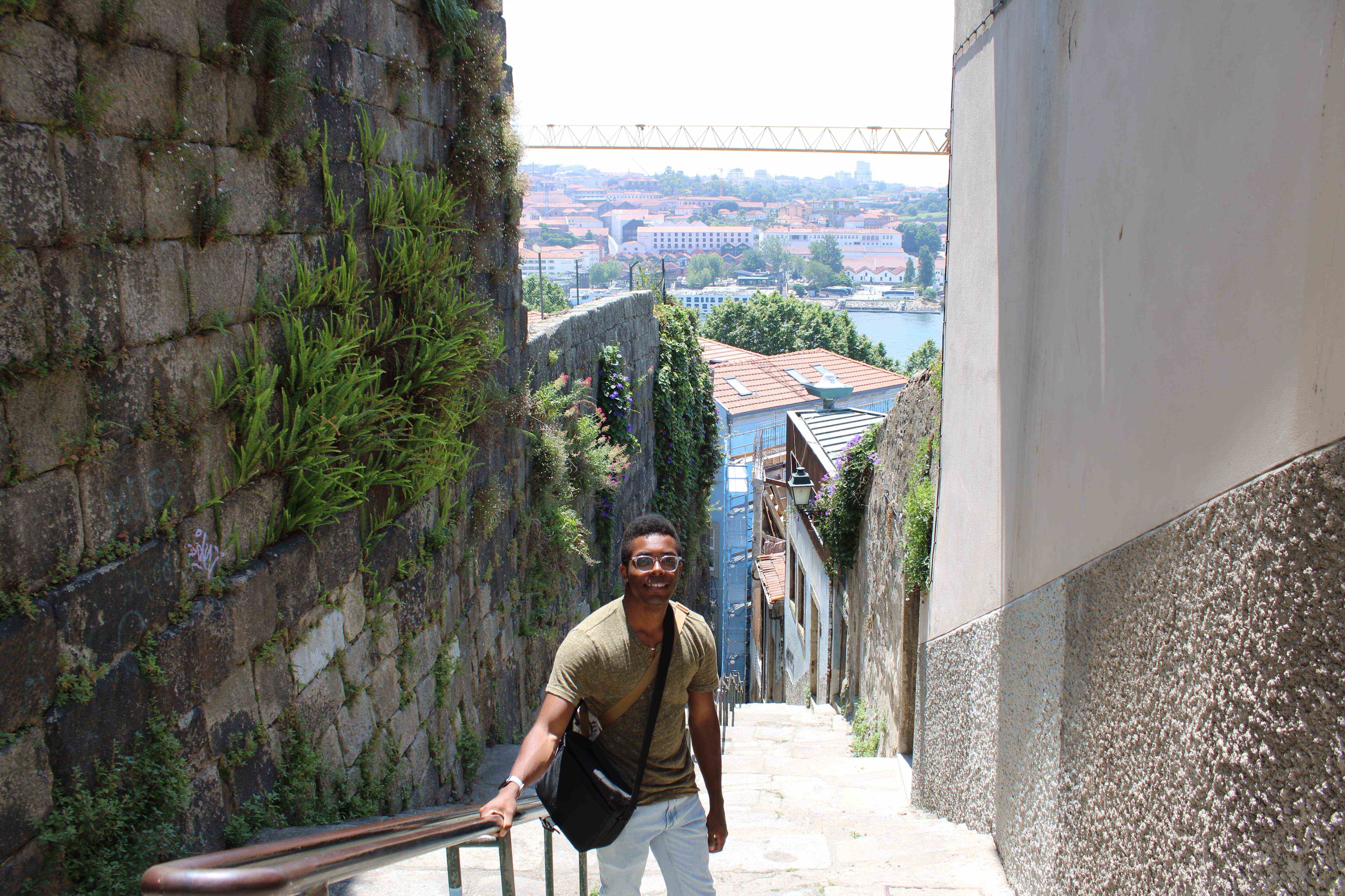 A photo of me standing atop a staircase in Porto.