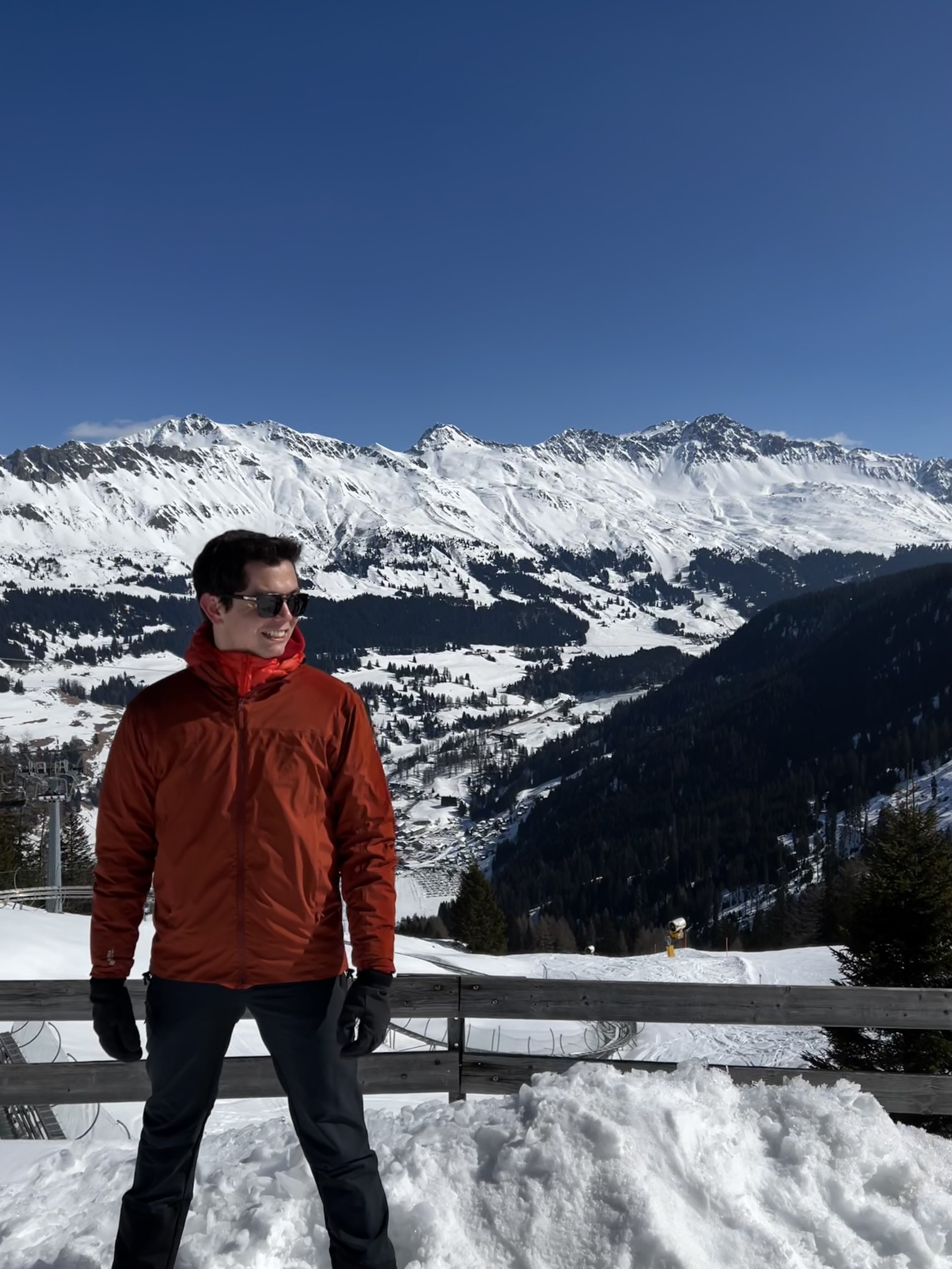 Student standing in front of snowy mountains (the Swiss Alps)