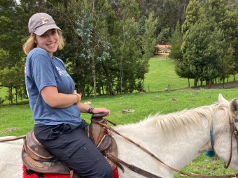 Chelsea horseback riding at a local farm during a team-building retreat.