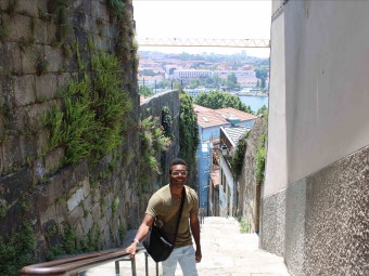 A photo of Dushaun standing atop a staircase in Porto.