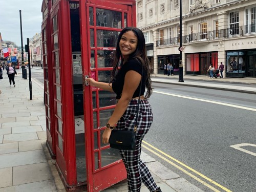 Student opening telephone booth in London