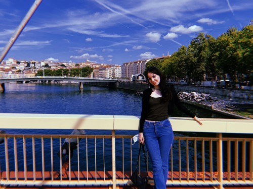 Student on a bridge in Lyon over the Saône River