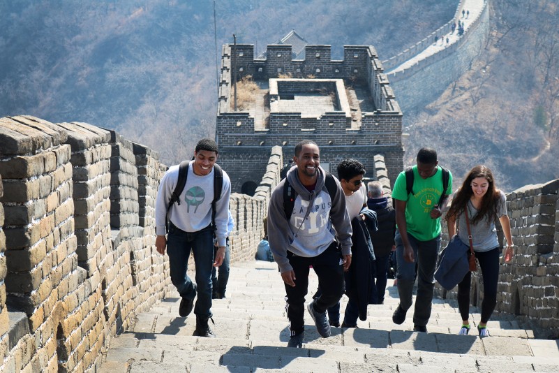 Students climbing the great wall of China.