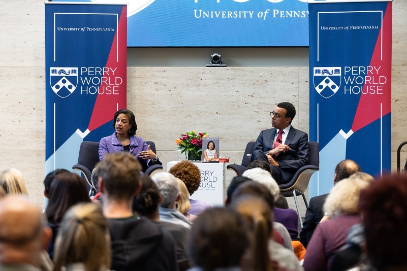 Susan Rice and Wendell Pritchett sitting side-by-side on stage in the World House Forum, speaking to a packed audience about Rice's new book. 