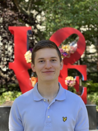 Picture of Filip in front of the Love Statue on Penn Campus