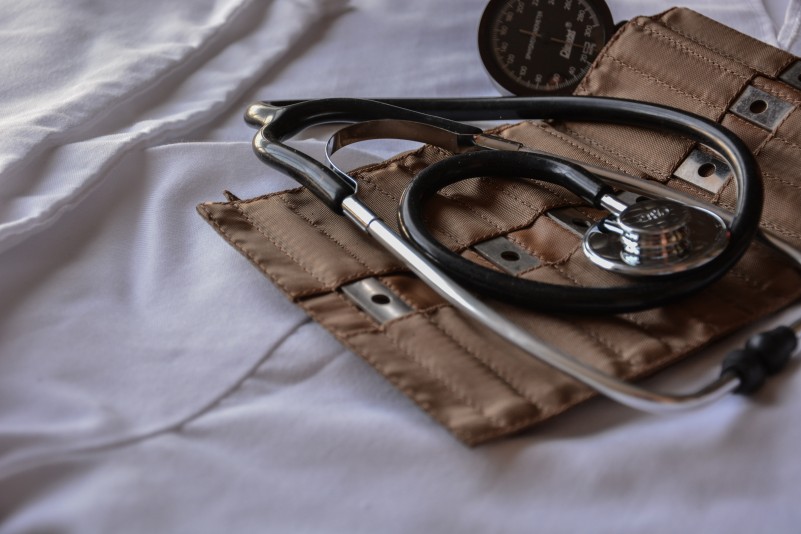 A stethoscope on a white bedsheet