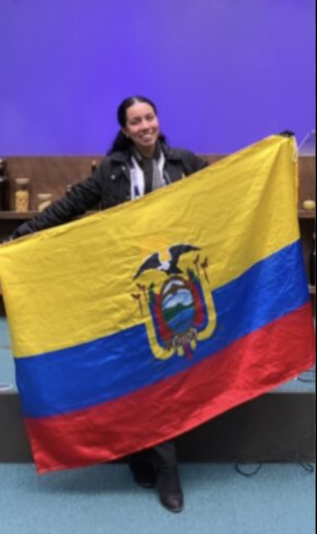 Alejandra Soria Andrade holding up an Ecuador flag