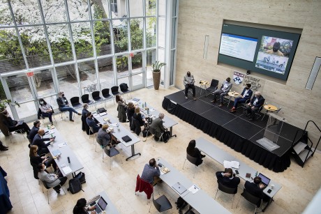 Aerial shot of the World Forum, with conference participants listening to panelists on stage.