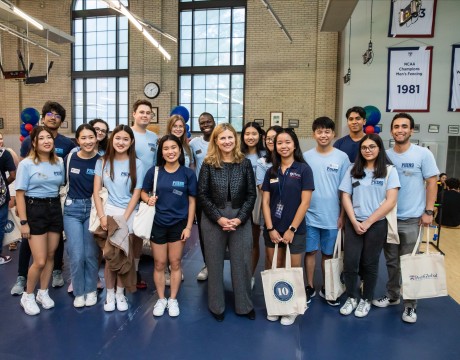 A group of iPhins standing next to President Magill at the 2022 welcome picnic for international students