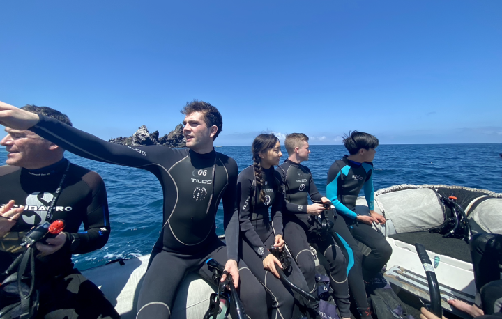 Students on a boat in diving gear in the Galapagos
