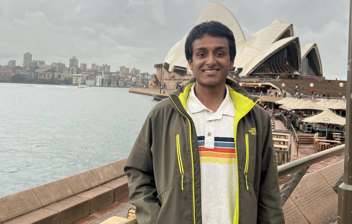 Student standing in front of Sydney Opera House