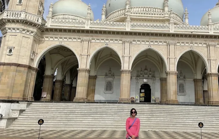 Student standing in front of large building in India