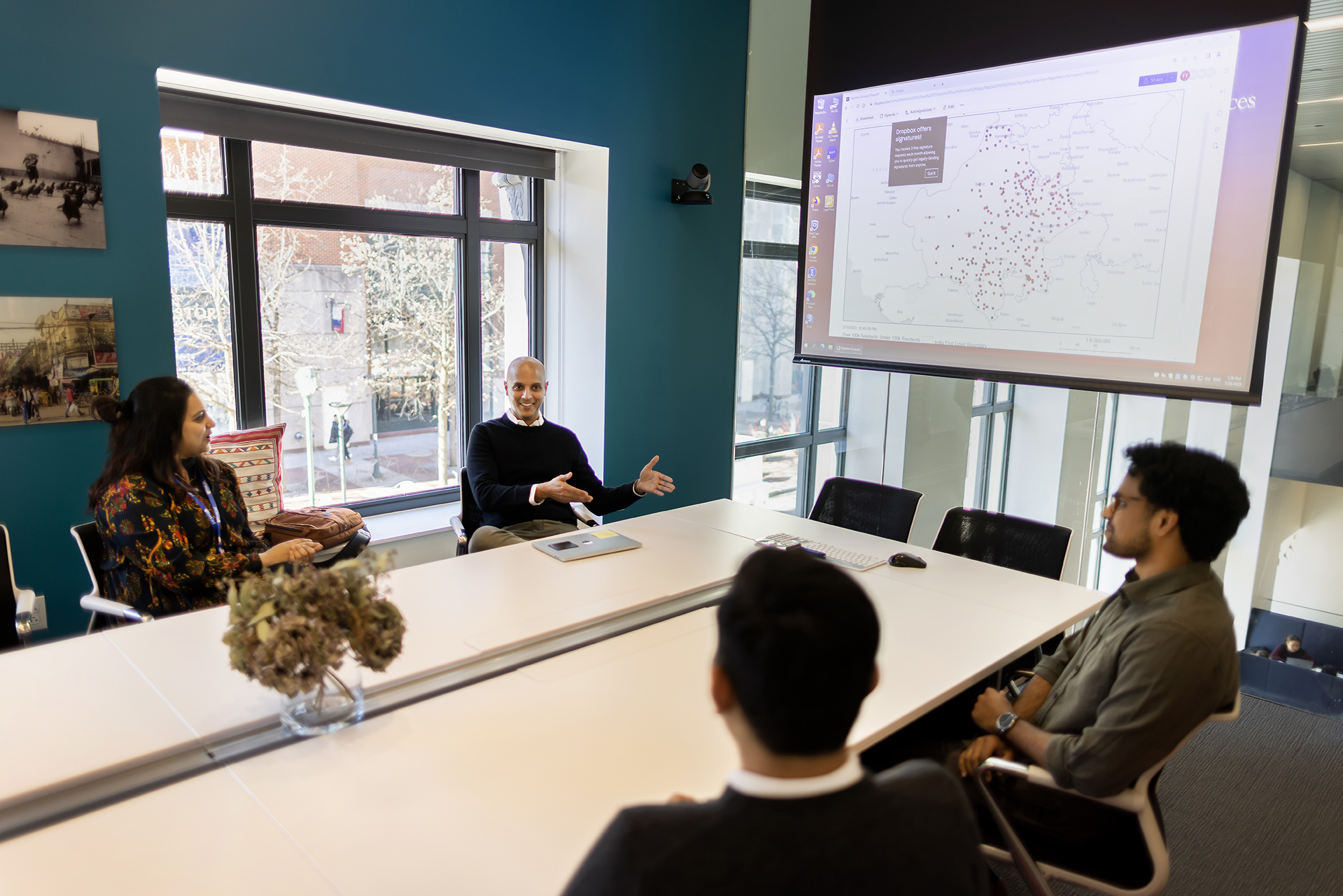 Group in conference room discussing research project