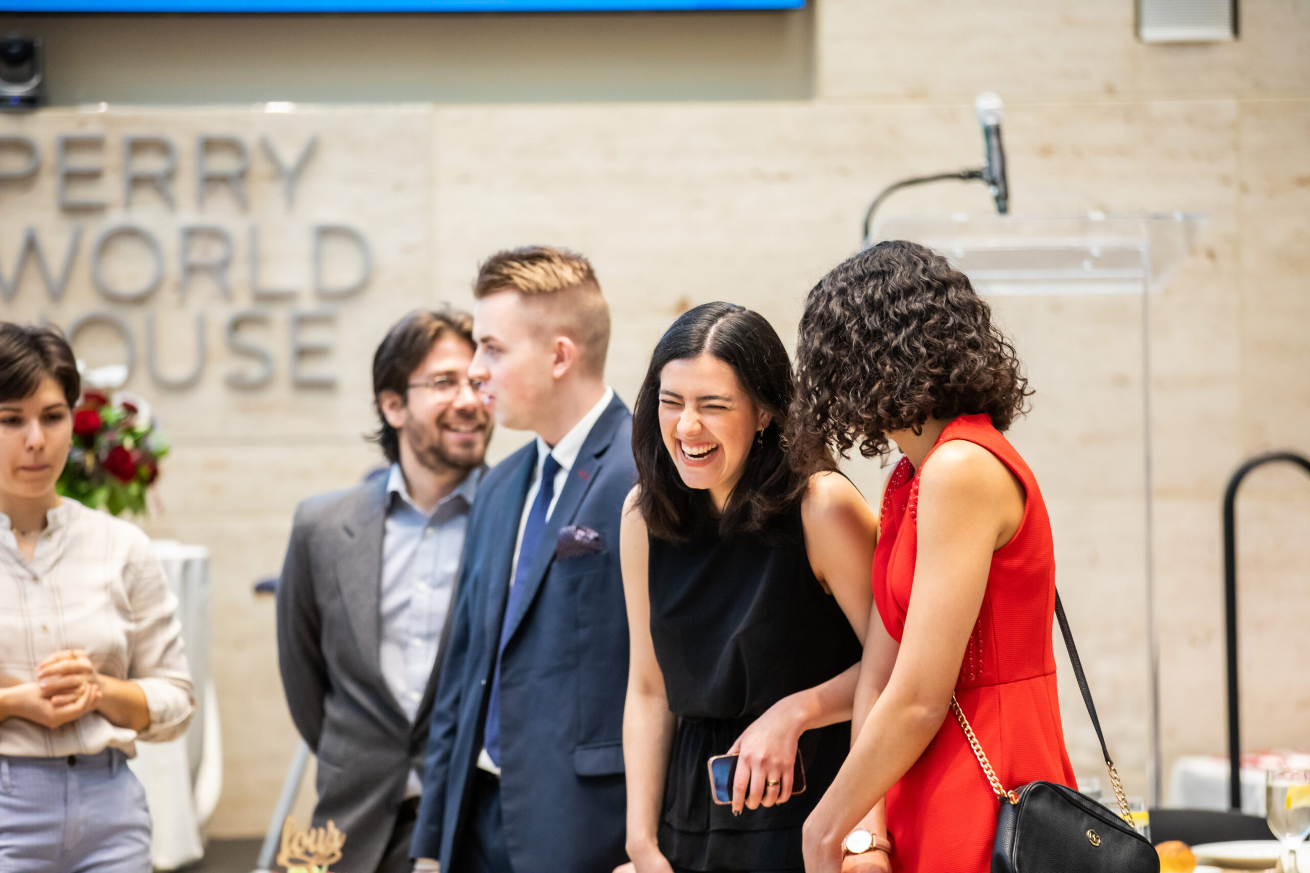 Two students in conversation with one laughing.